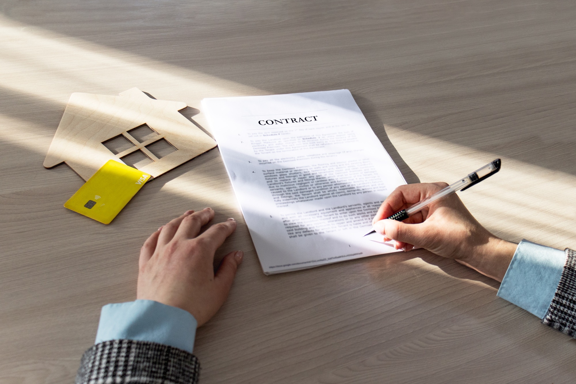 contract for the sale of a house.Home Mortgage Agreement, Real Estate Concept.symbol, wooden house
