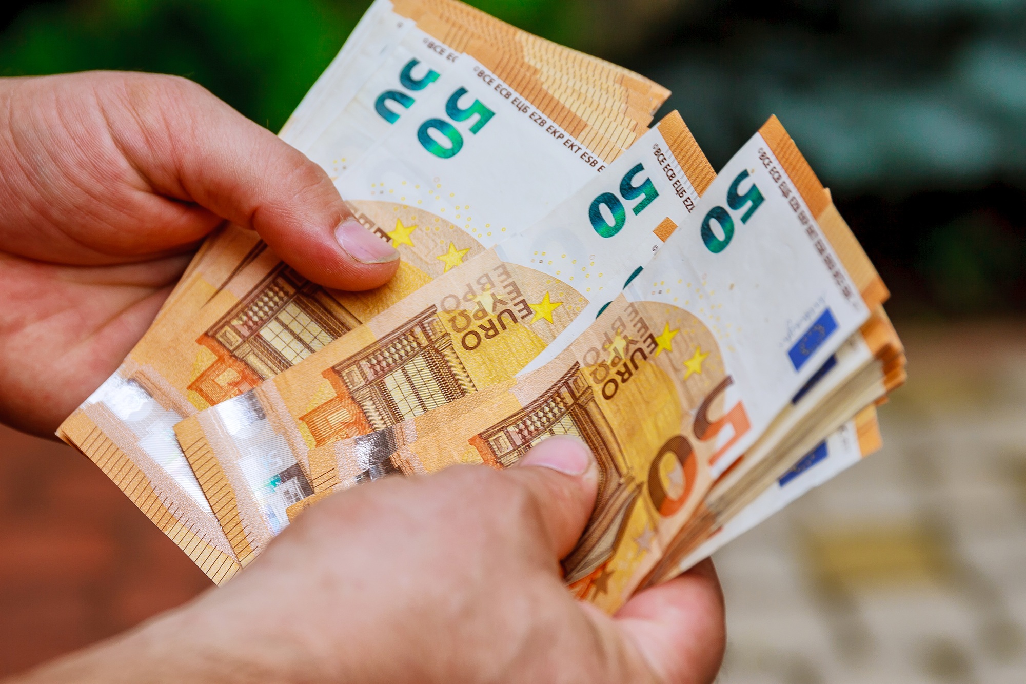 Man hands counting us euro banknotes. Counting or spend money.