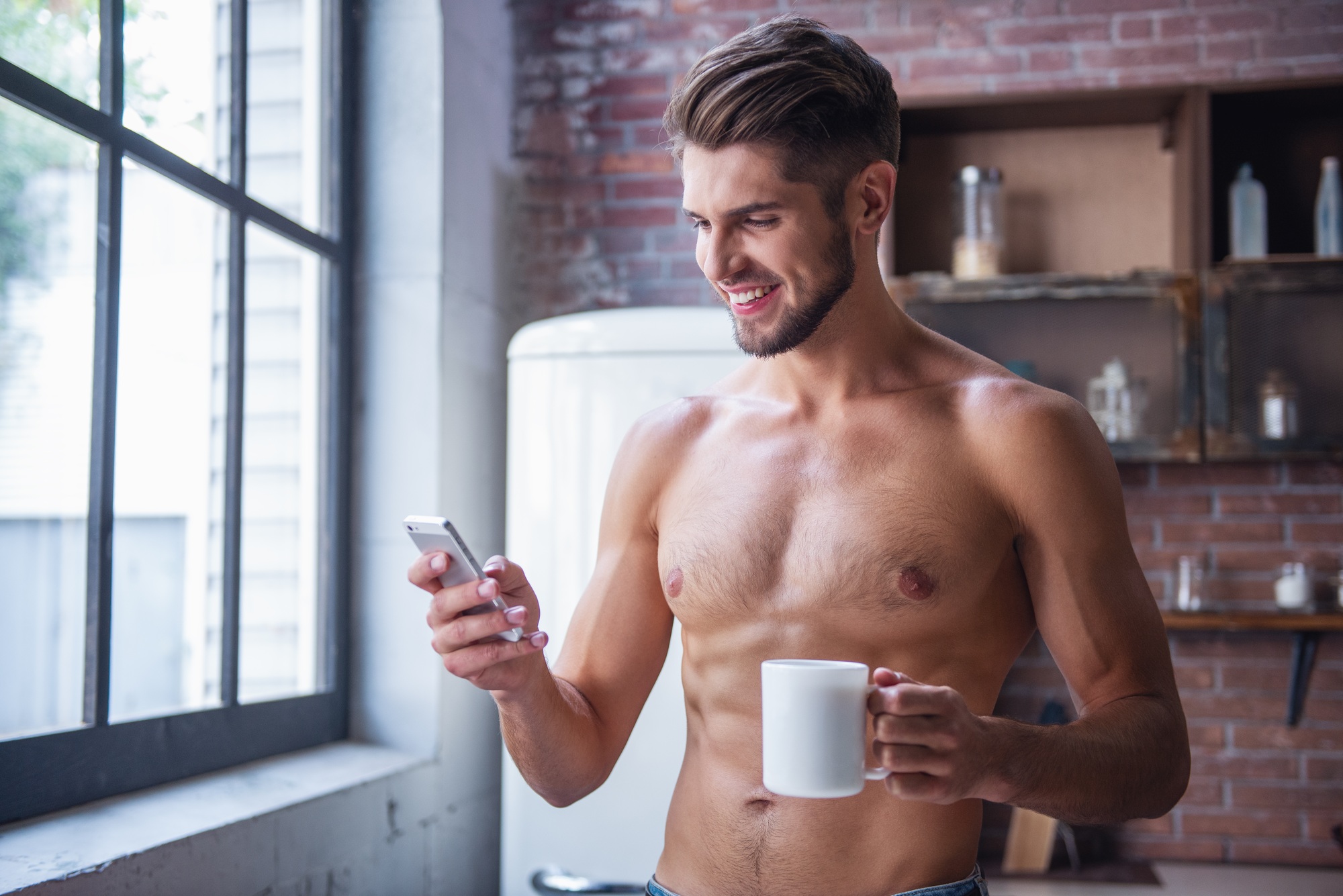 Sexy young man in kitchen