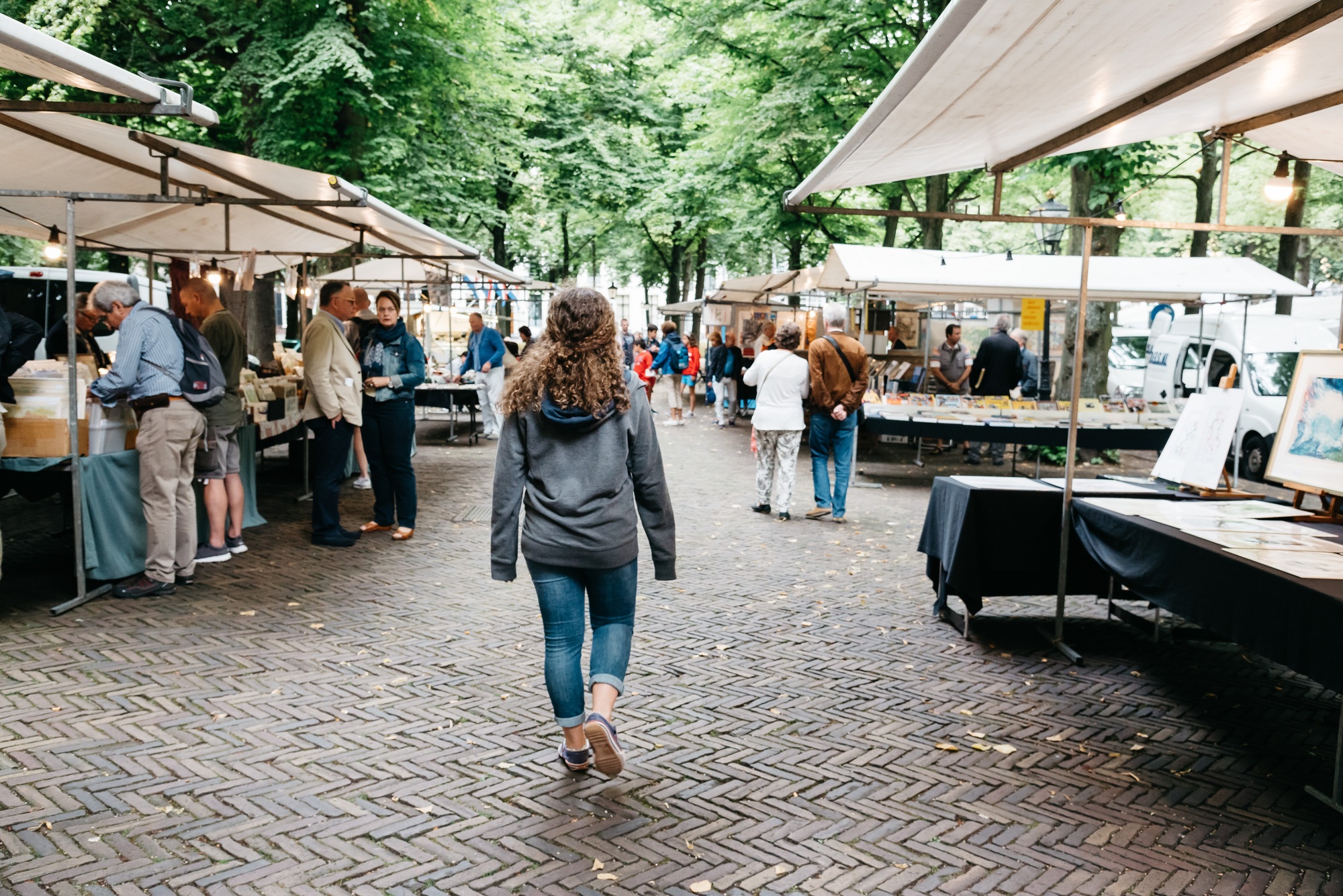Unidentified people in a book and antiques market stall in the street of The Hague